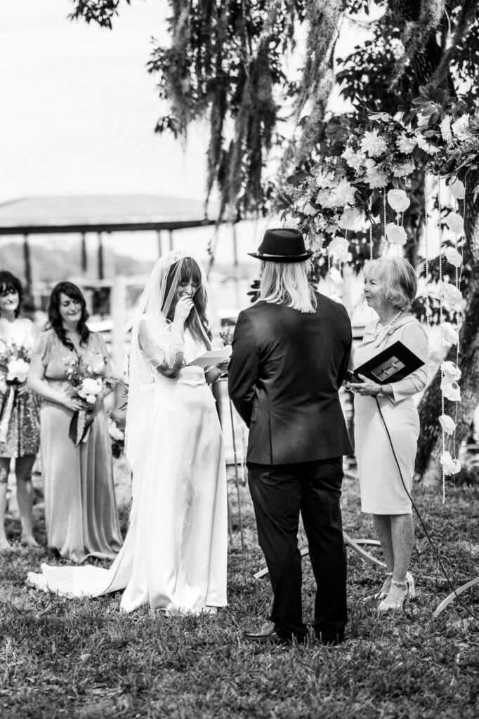 bride getting emotional during wedding ceremony in this black and white photo by Jacksonville wedding photographer