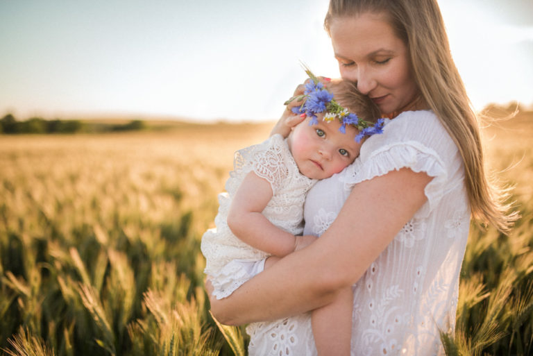 baby girl on her mom in the field | jacksonville children photographer