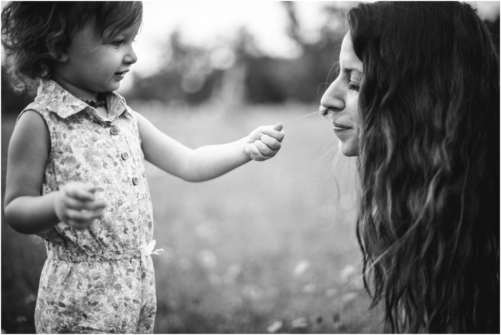 baby girl sharing flowers with mom during flower field session| jacksonville children photographer