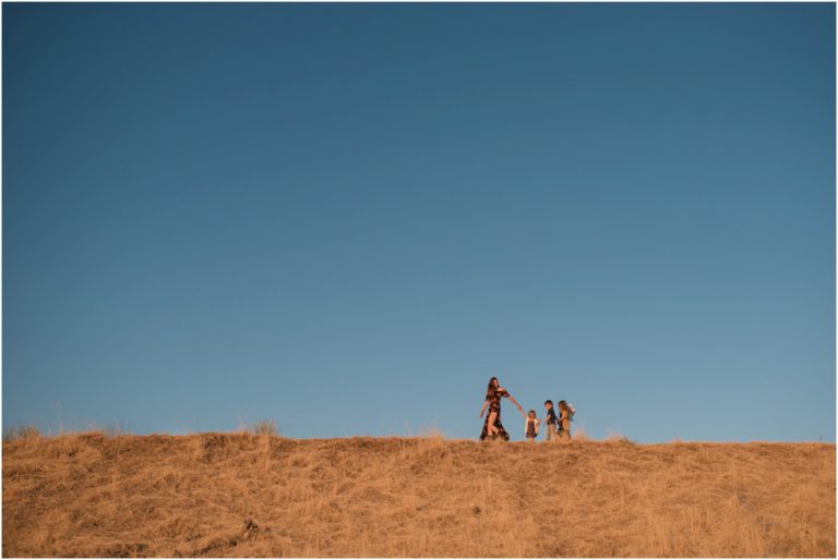 mom with 3 children walking on the hills | jacksonville family photographer