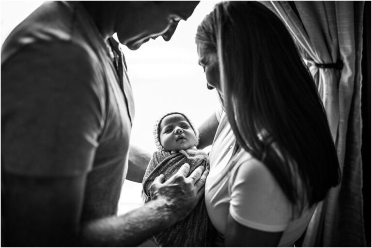 Jax newborn photographer and a week old baby with his parents. Jacksonville FL at home newborn session. First days together with a newborn baby.