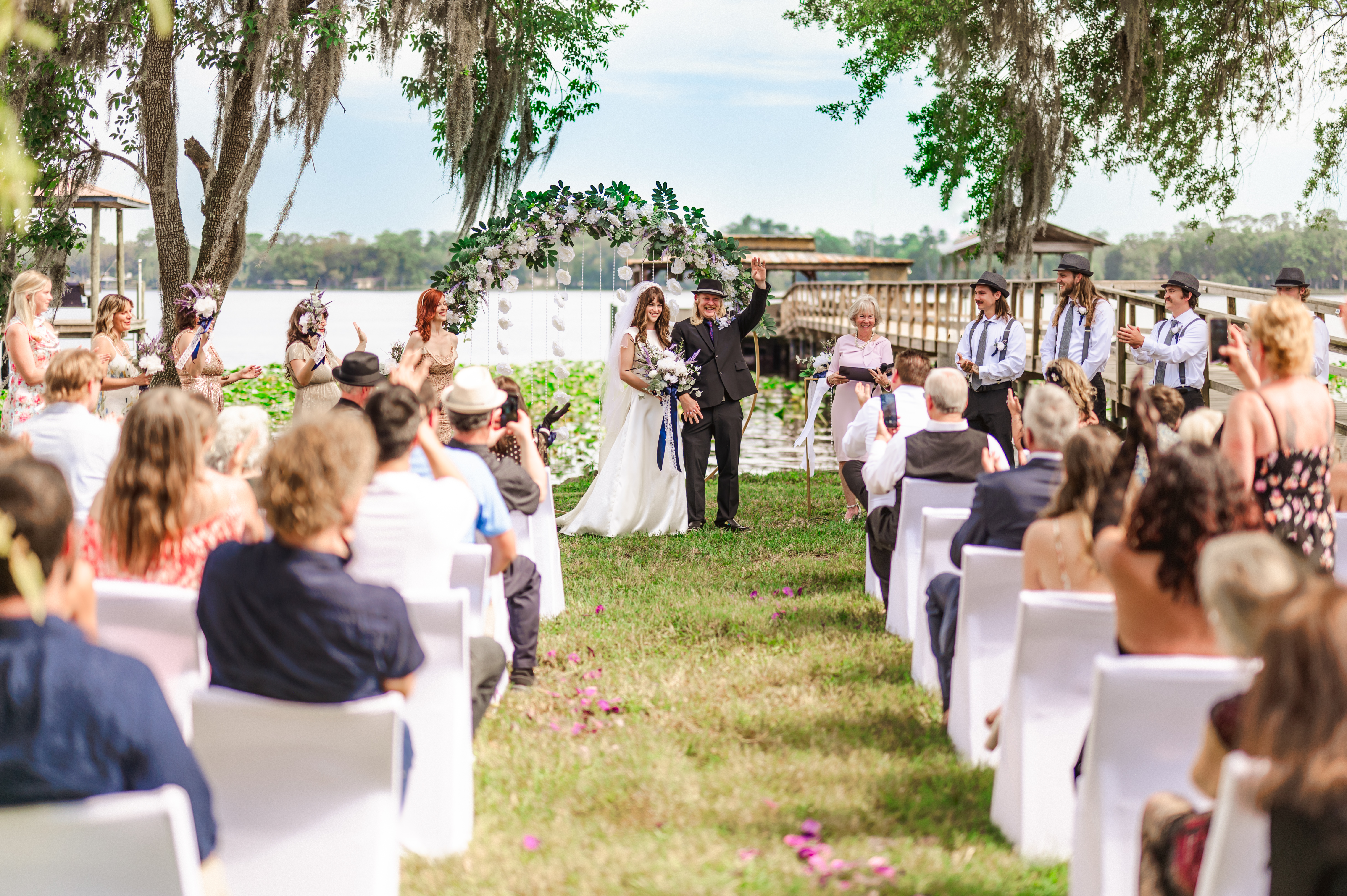 wedding couple getting married as Jacksonville photographer captures them through the aisle in their outdoor wedding