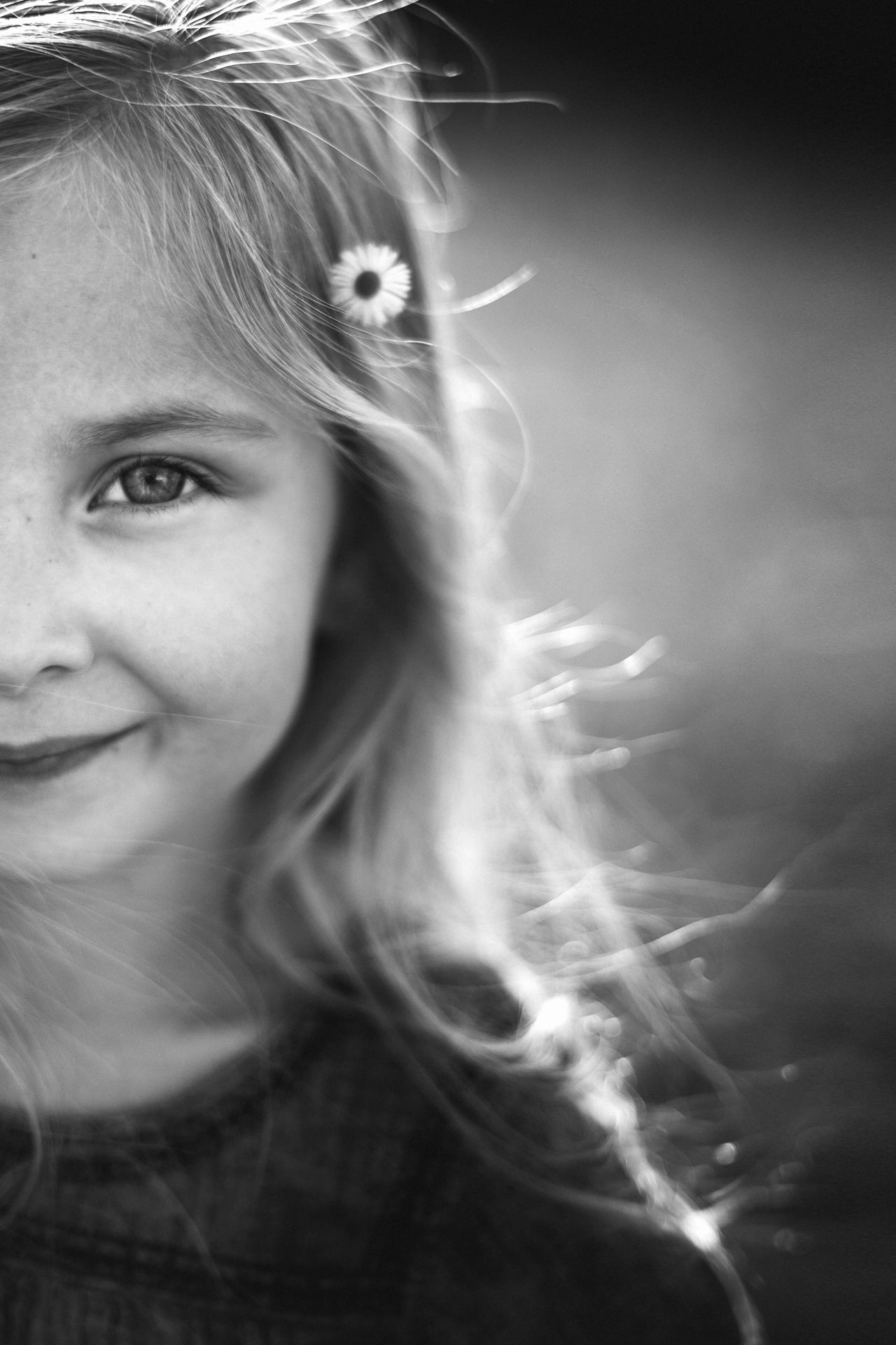 close up of young girl smiling in black and white photo in a Jacksonville children's photoshoot