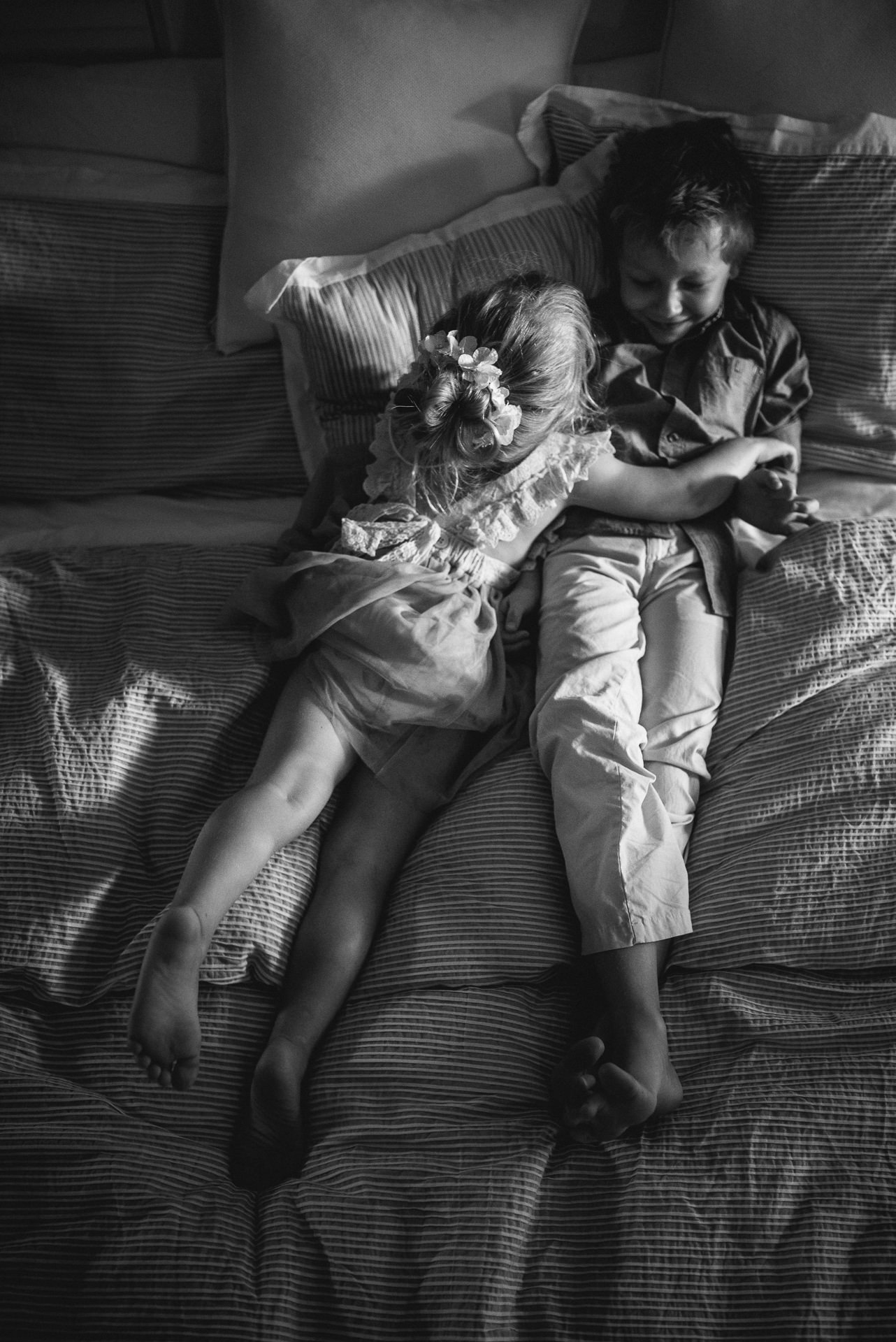 children play on a bed in a Jacksonville children's photoshoot