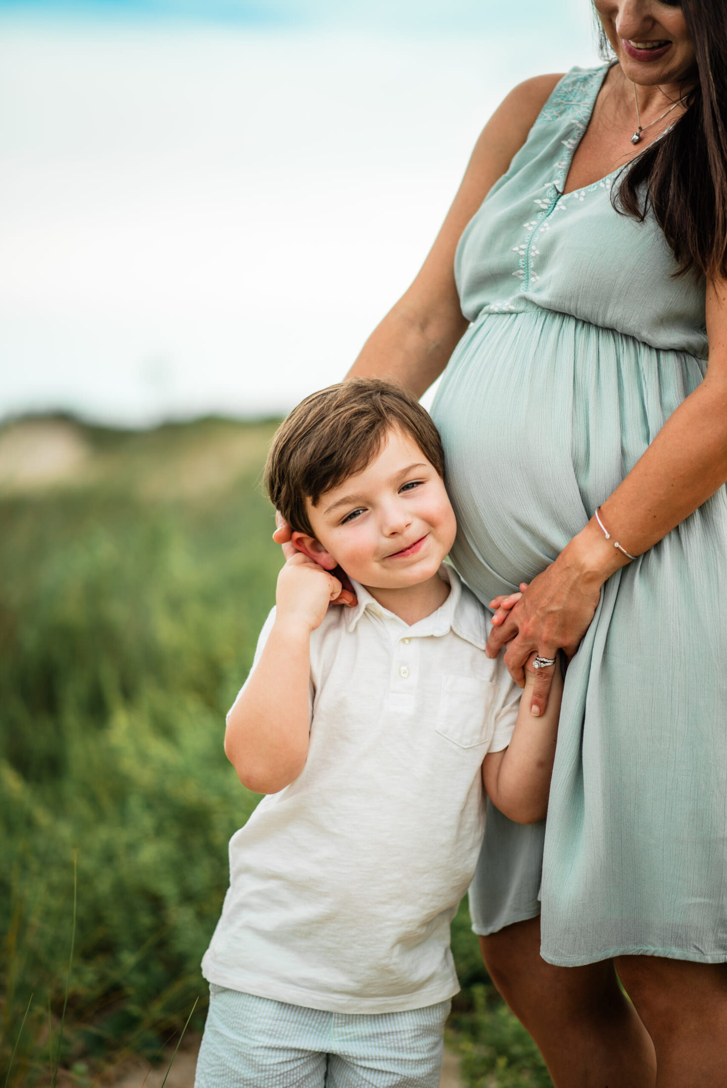 close up of child posing with pregnant mother in a Jacksonville children's photoshoot