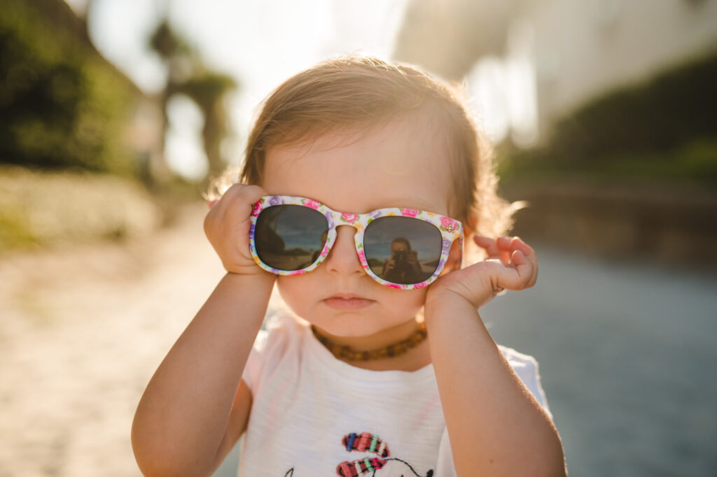 young child posing with sunglasses in a Jacksonville children's photoshoot