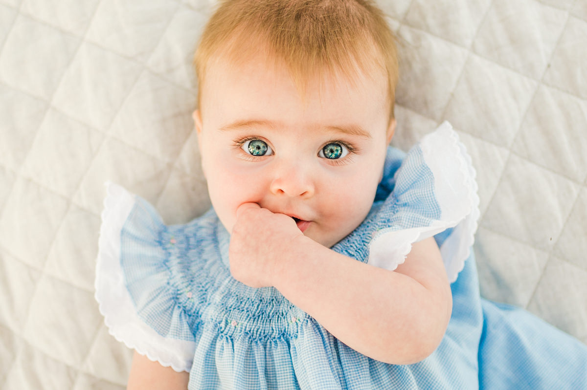 baby smiling looking up at camera in a Jacksonville children's photoshoot