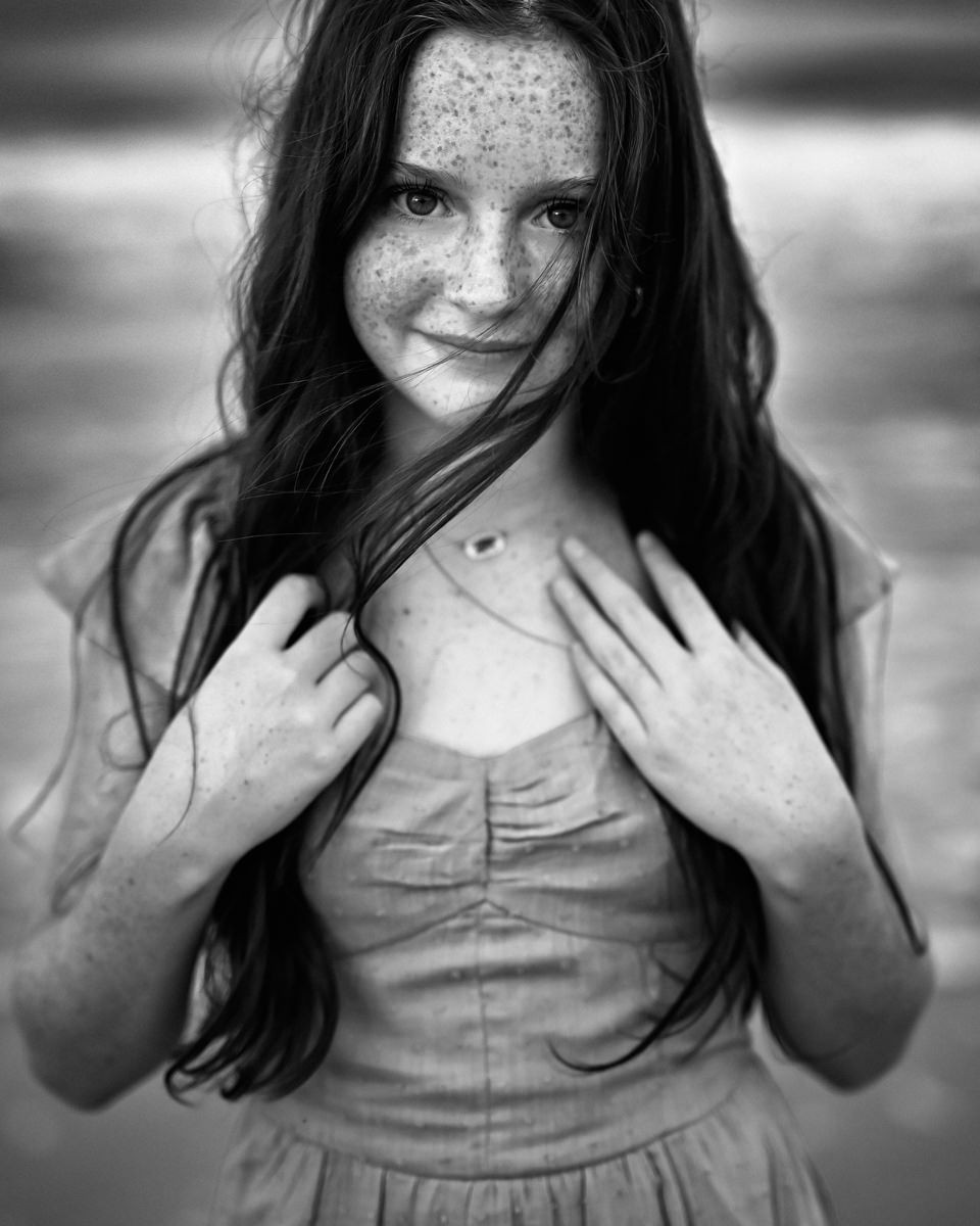 young girl smiling in a black and white photo in a Jacksonville children's photoshoot