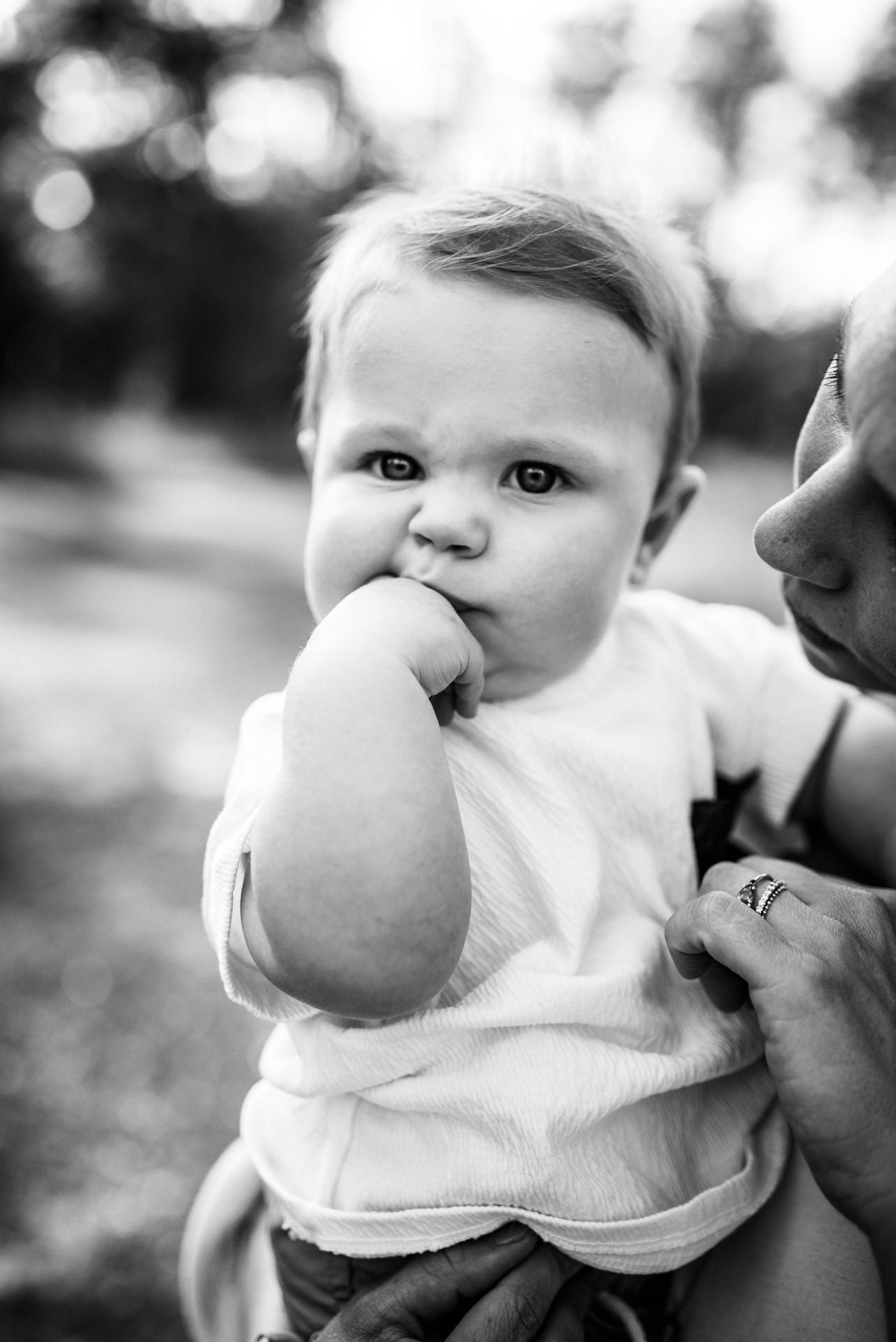 close up of baby with hand in their mouth in a Jacksonville children's photoshoot
