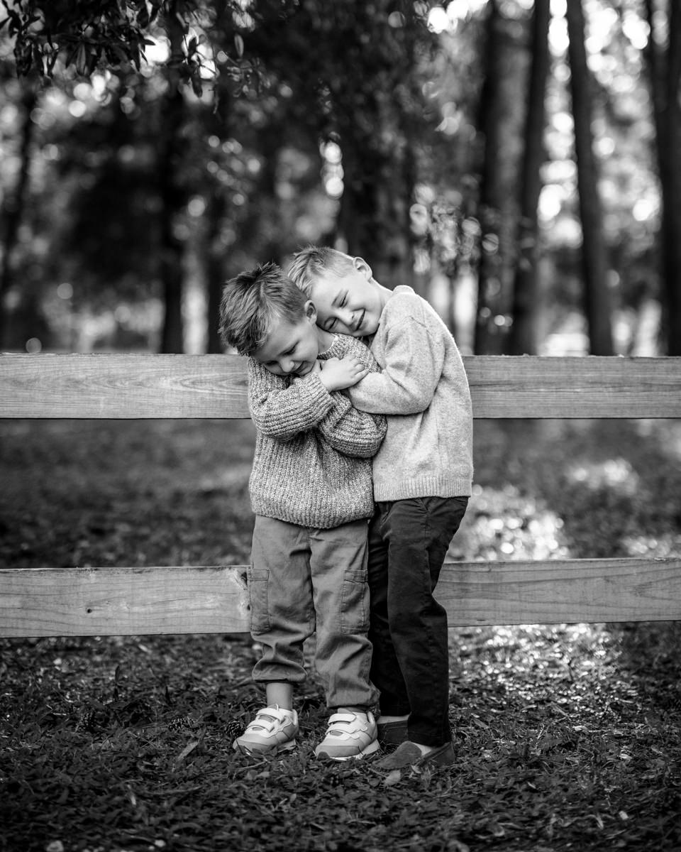 two young children hugging each other in a Jacksonville children's photoshoot