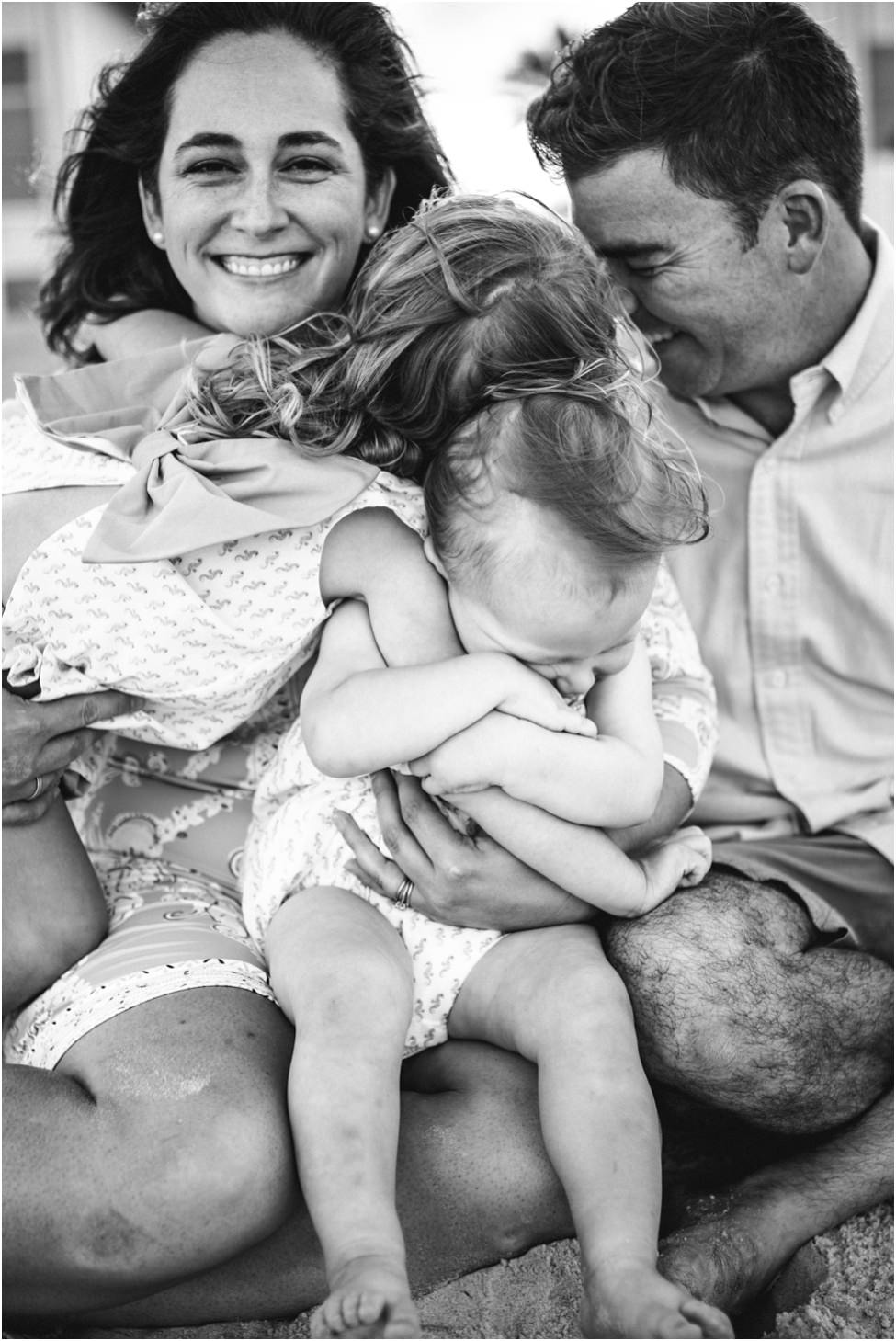 Close up of parents and two small children playing and laughing in a family photoshoot in Jacksonville FL
