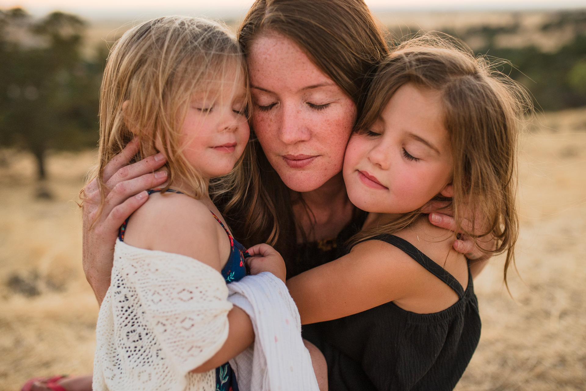 Mother and children hugging in close up photo in a family photoshoot in Jacksonville FL