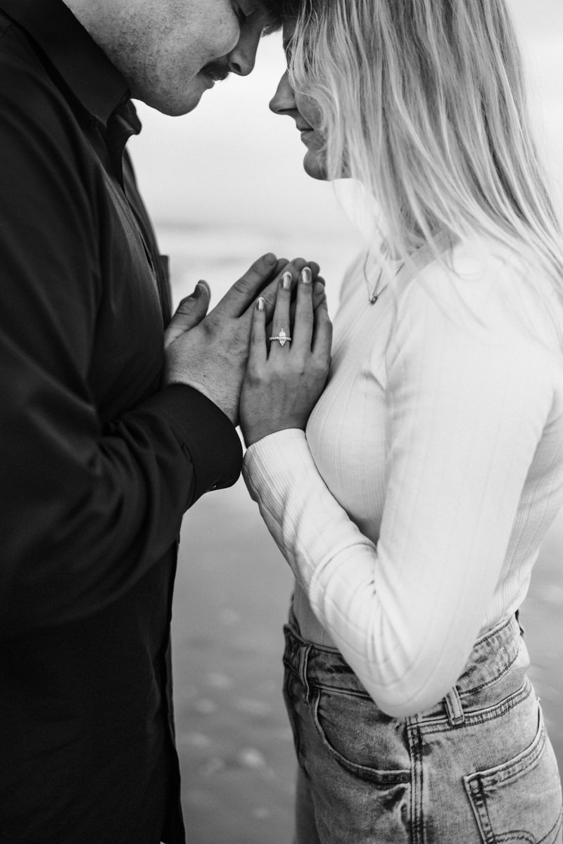 close up of couple holding hands facing each other in a jacksonville couples photoshoot
