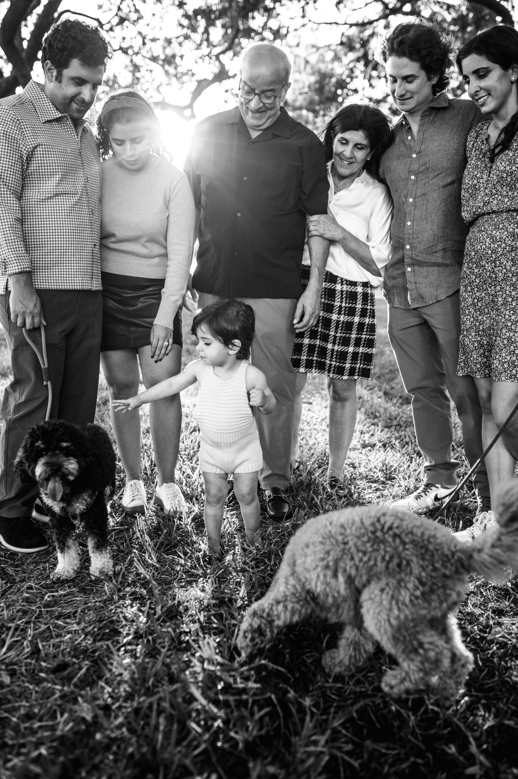 Black and white photos of extended family session with their dogs in Jacksonville park