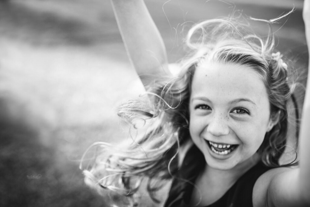 Happy girl captured in the white and black portrait during family session by Jacksonville photographer