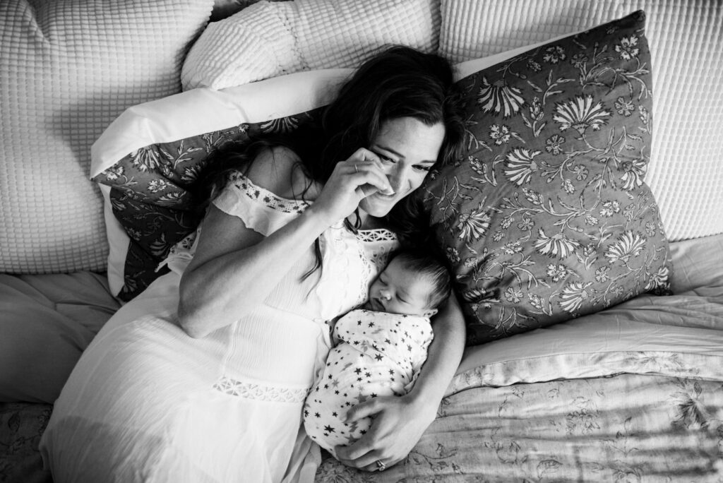 Emotional black and white photo of mom and her new baby crying out of happiness by Jacksonville newborn photographer