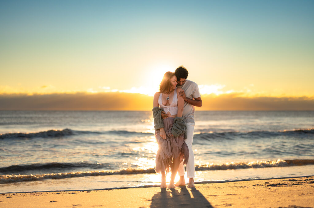 couple loving on each other on the beach shore in a jacksonville couples photoshoot